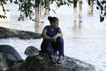 Sitting on a rock by the water